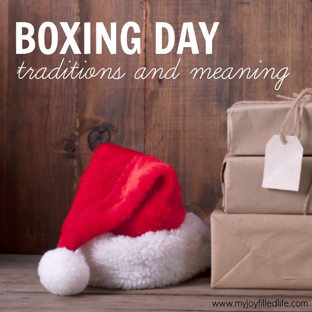 boxes with Christmas presents and santa hat on a wooden background