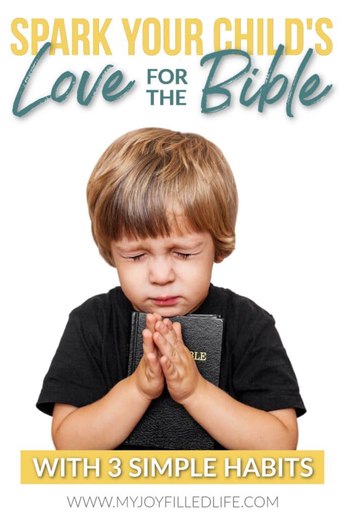 Young boy praying while hugging a Bible