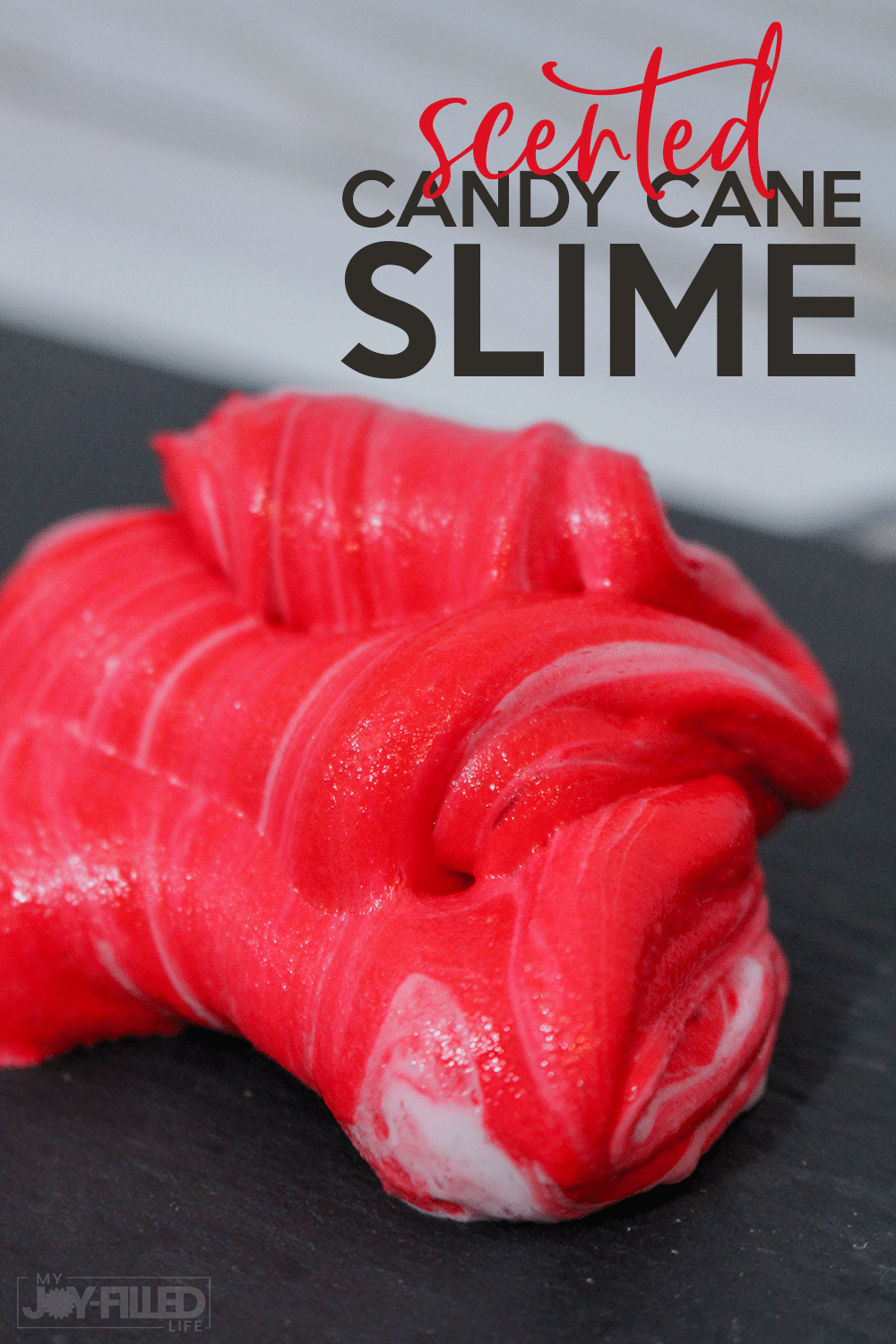 This candy cane slime is such a fun slime recipe for Christmas - it even smells like peppermint! Kids will have so much fun getting into the Christmas spirit with this slime. #slime #slimerecipe #christmas #candycanes #christmasslime