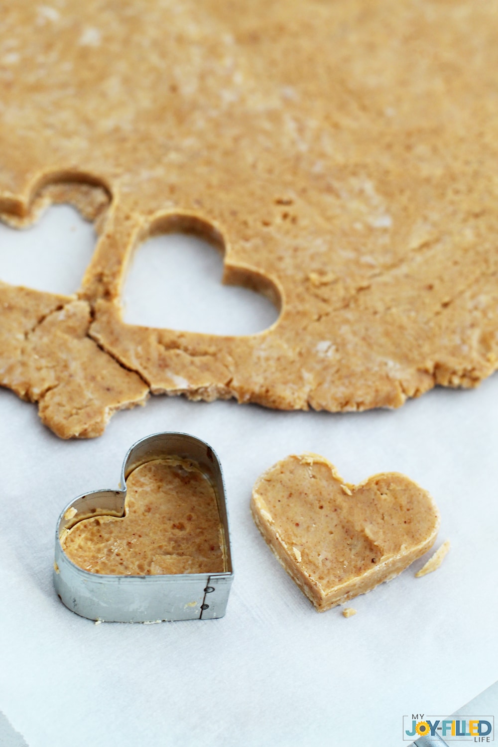 Cutting out peanut butter hearts for homemade copycat Reese's hearts