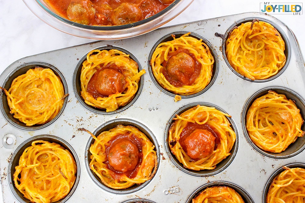 mix meatballs and sauce together for spaghetti and meatball cups