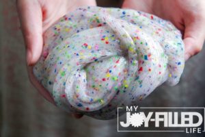 hands holding crayon slime
