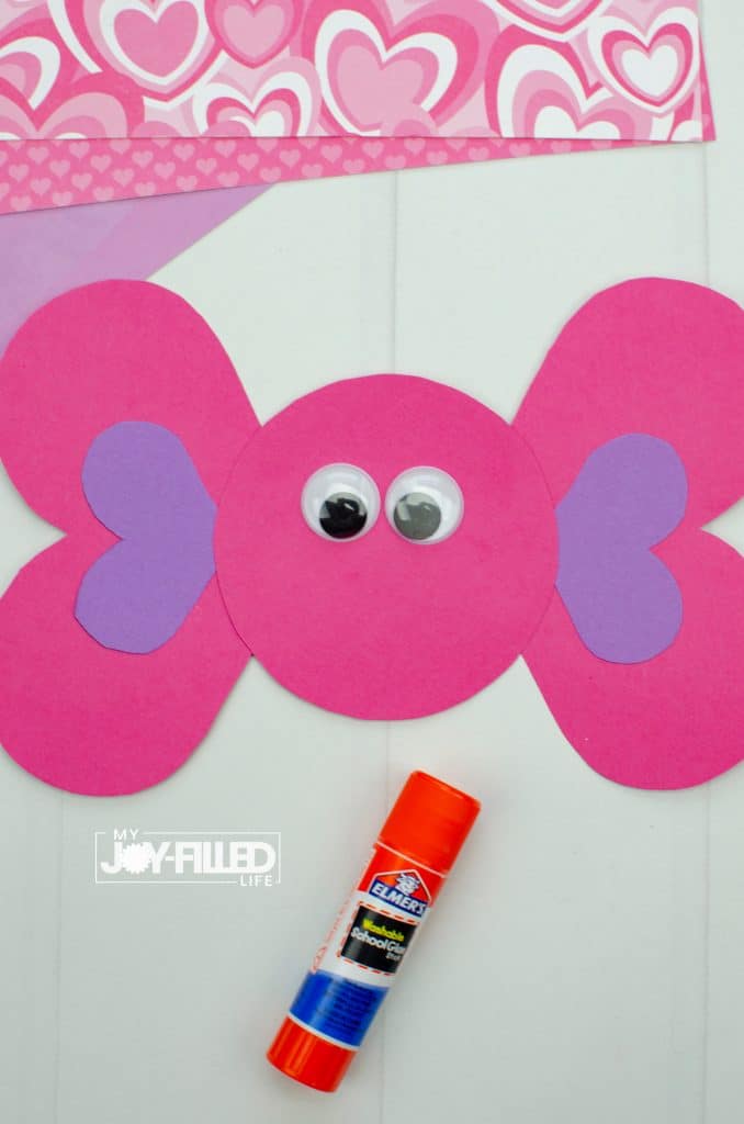 Shape cut-outs glued together for Valentine craft with glue stick and googly eyes.