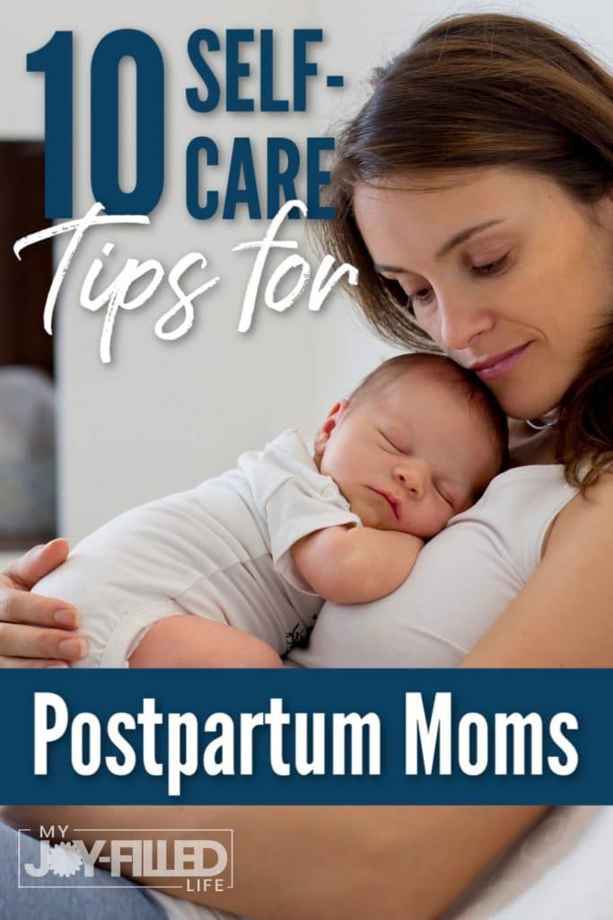 Postparum mom snuggling with sleeping newborn baby on her chest