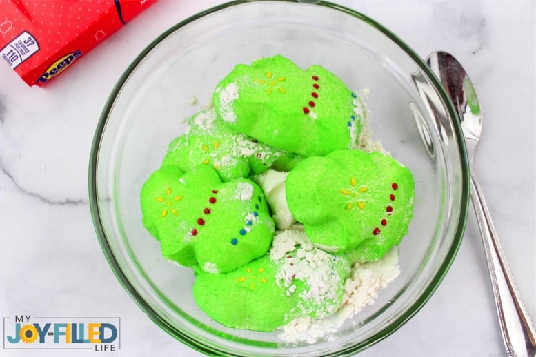 Mixing up Christmas Playdough in a bowl