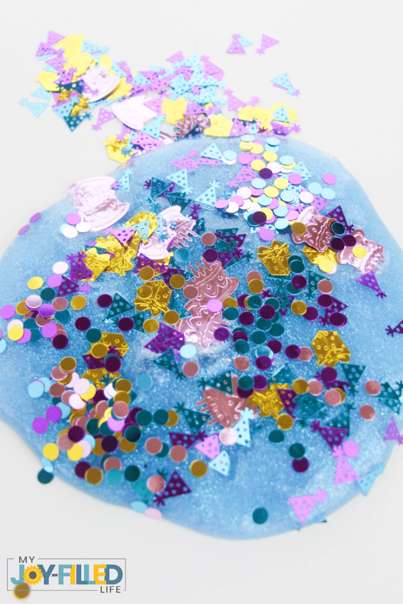 Mixing glitter and confetti into the slime