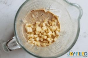 adding the apples to the blender