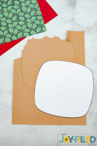 tracing the shape on the brown paper