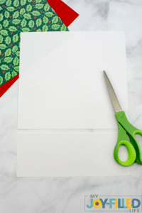 cutting the white paper in a square