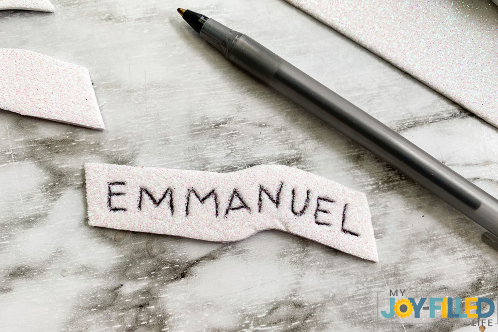 writing the word emmanuel on felt 