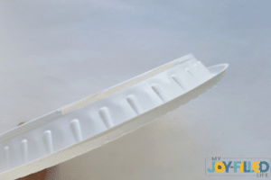 folding the plate to add the popsicle stick