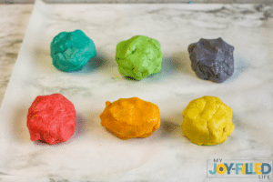 adding the food coloring to the cookie dough
