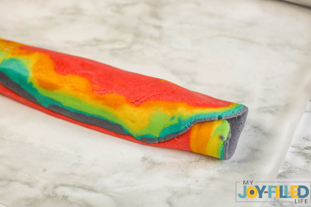 rolling the rainbow cookie dough 