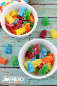 colorful homemade sour gummy bears in a white dish